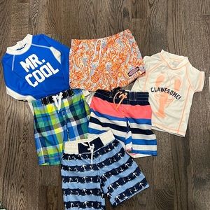 Bundle of swim trunks and rash guards